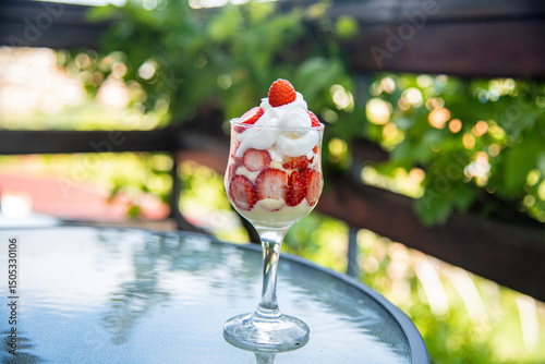 Strawberries and cream delicious sweet dessert with nature green background