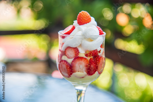 Strawberries and cream delicious sweet dessert with nature green background