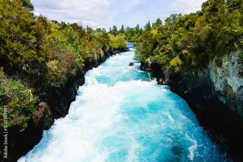 Waikato River flowing swiftly through Huka Falls canyon.