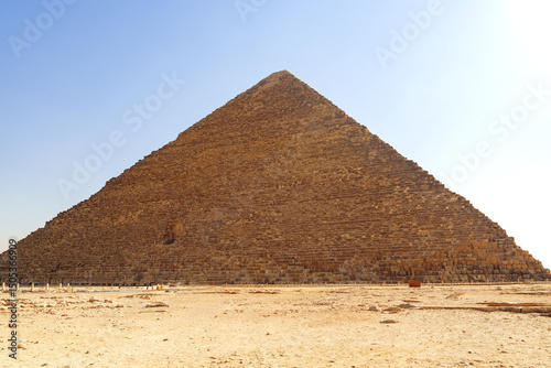 Majestic pyramid stands tall under bright sky at Giza, showcasing ancient Egyptian architecture and history