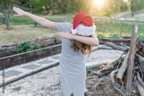 teen girl in xmas hat outdoors, dabbing photo
