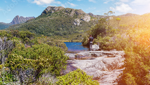 a man pauses at a viewpoint whilst hiking in Tasmania
