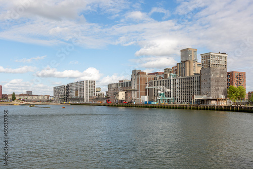 Katendrecht seen from across Rijnhaven with old industrial processing factory and silo building on the shore of the Maas river in the Dutch city of Rotterdam