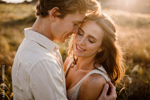 Man and woman in the middle of a field on a summer evening.