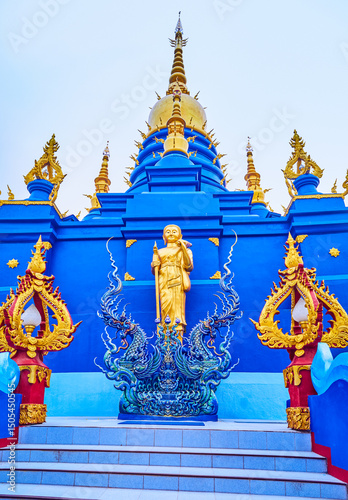 Chedi of Wat Rong Suea Ten in blue color with golden elements, Chiang Rai, Thailan photo