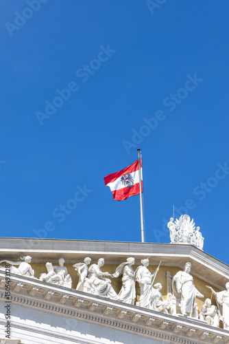 Flag Austria on the building of the Austrian Parliament. Facades of historical buildings Austria, Vienna