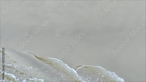 Turbid water flow with waves. Brown background.