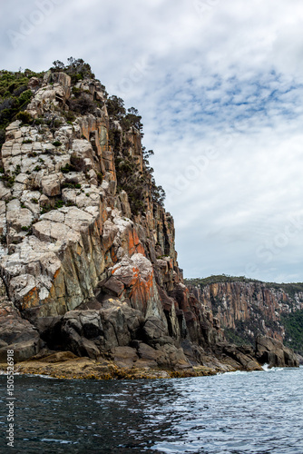 A view of towering sea cliffs from the water