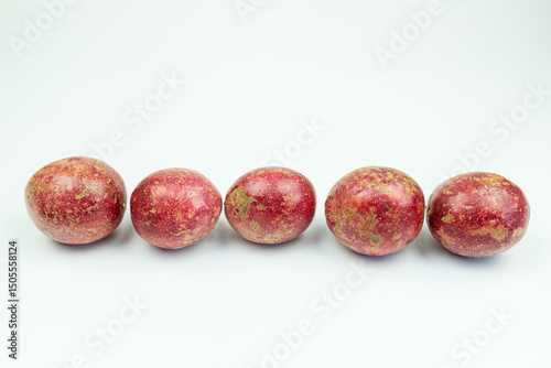 Fototapeta Naklejka Na Ścianę i Meble -  A pile of passion fruits on a white background