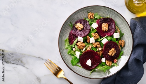 beetroot and goat cheese salad with candied walnuts isolated on a white marble background