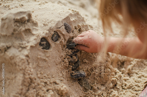 Child making sandcastles photo