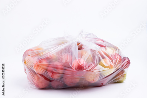 Fresh red plums in a transparent plastic bag