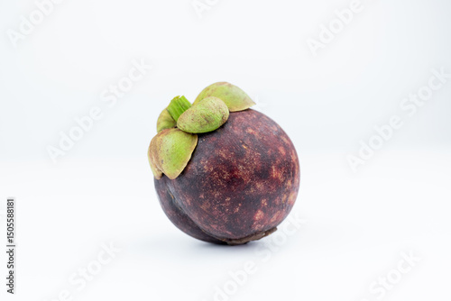 A mangosteen fruit on a white background