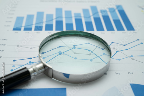 Magnifying glass on charts graphs paper. Financial development, Banking Account, Statistics, Investment Analytic research data economy.