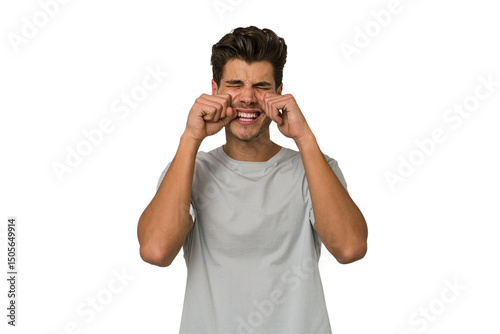 Obraz na płótnie Young handsome caucasian man isolated on white background whining and crying disconsolately