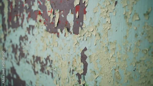 Texture of peeling paint on a metal wall. Close-up of a metal surface with old peeling paint