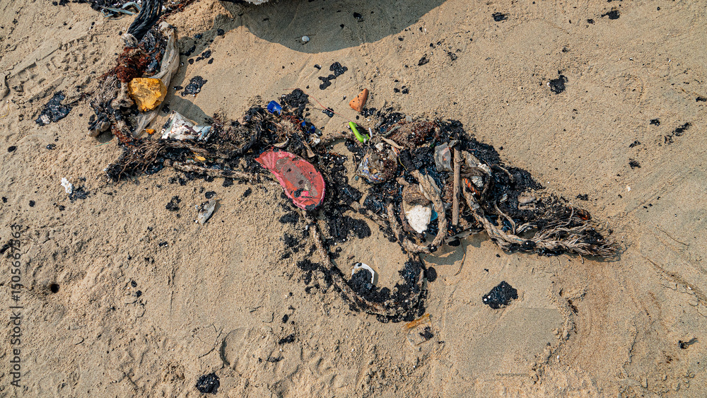 Obraz premium Oil pollution of sea, coast. Floating objects (flotsam, fragments of fishing nets) are covered with fuel oil and bring toxin to other parts of sea, secondary pollution. South China Sea