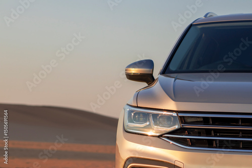 Close-up of a grey SUV in desert sand during sunset — a real and powerful image of adventure, style, and quiet strength in a dramatic natural setting.