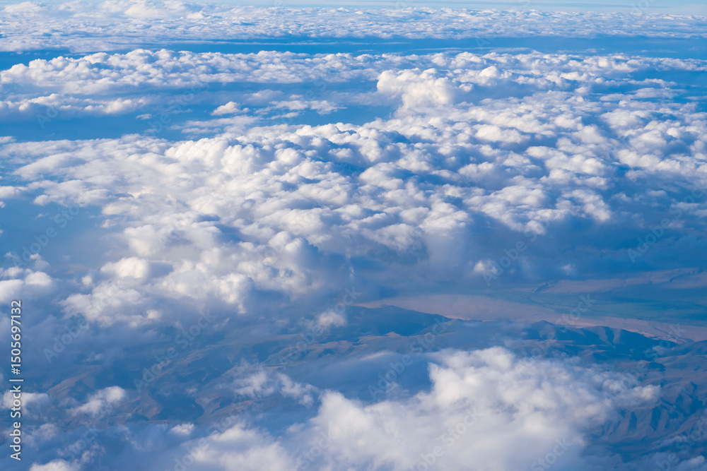 Fototapeta premium Aerial cloudy sky view. Cloud view from plane. Sky in cloud. Cloudscape with cloudy weather. Cloud and cloudscape aerial sky. Aerial cloudscape view covered with cloud. Dramatic cloudscape