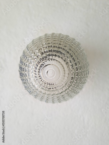 Globe-shaped wall lamp made of glass.