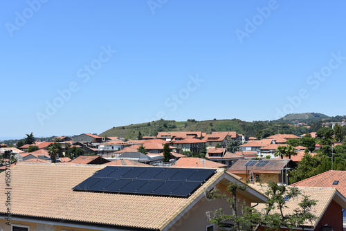 Solar photovoltaic panels on a house roof. The concept of a sustainable environment, construction. Residential homes in Sicily, Italy. 