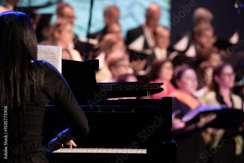 Pianist playing grand piano with choir singing in background