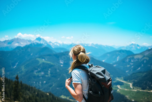 Serene mountain hiker gazing at breathtaking landscape on a sunny day