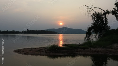 Natural video background of a high-angle atmosphere on a mountain that overlooks the surrounding scenery(mountains, trees,sea)from a scenic vantage point,with a wooden chair for sitting and resting photo