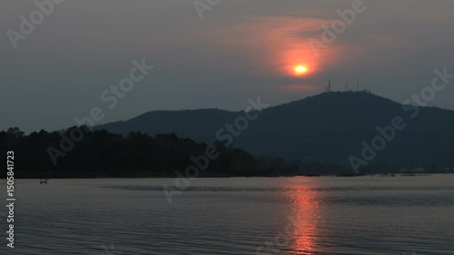 Natural video background of a high-angle atmosphere on a mountain that overlooks the surrounding scenery(mountains, trees,sea)from a scenic vantage point,with a wooden chair for sitting and resting photo