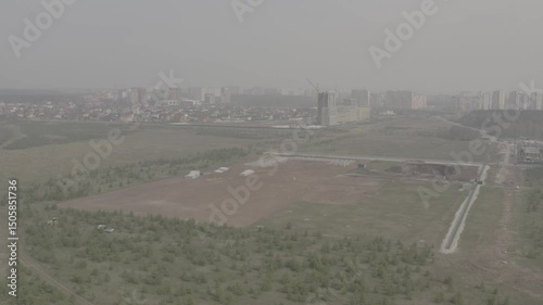 Tobolsk, drone, aerial photography, quadcopter, planting of young fir trees, outskirts of the city, city view, multi-storey new buildings, private houses, quarry, fields, forest belt, playground
