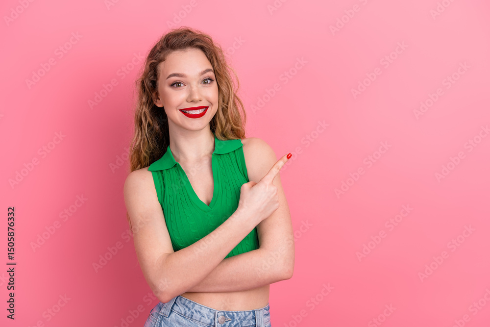 Young woman in a stylish green top gestures happily against a pink background, exuding confidence and charm Young woman in a stylish green top gestures happily against a pink background, exuding confidence and charm