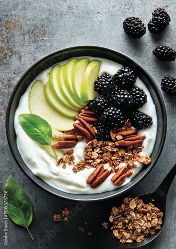 Healthy Breakfast Bowl With Yogurt, Fruits, Nuts, and Granola in a Rustic Kit...