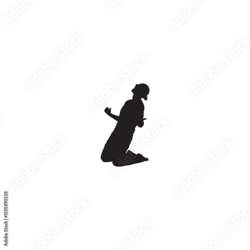 Silhouette of an excited person kneeling with arms raised in victory