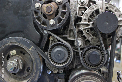 Overhaul of the timing belt mechanism of the gasoline engine on a workbench at a car shop. Dismantled from car engine on a checking stand for repair  