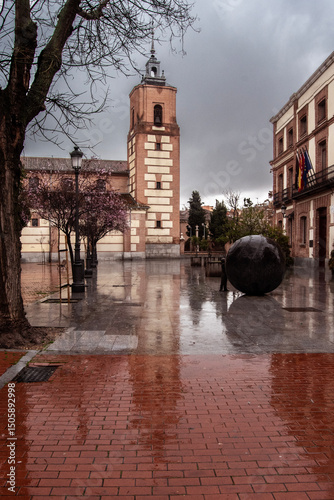 Reflection of the tower of the San Sebastian Church in Madrid on a rainy day