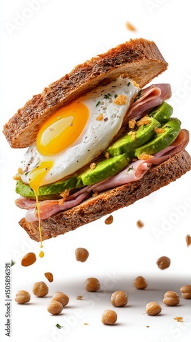 Colorful Sandwich With Layers of Ham, Avocado, Egg, and Greens Floating in Mi...