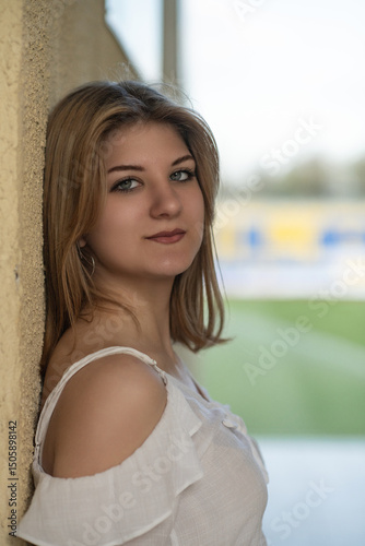 Free Download Portrait of a young beautiful blonde girl in a city environment on a summer day. - GFXLoad