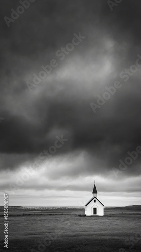 Black and White Chapel Under Dramatic Cloudy Sky in Isolated Landscape at Dusk