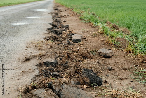 Wallpaper Mural A road with a large crack in it and a grassy area next to it Torontodigital.ca