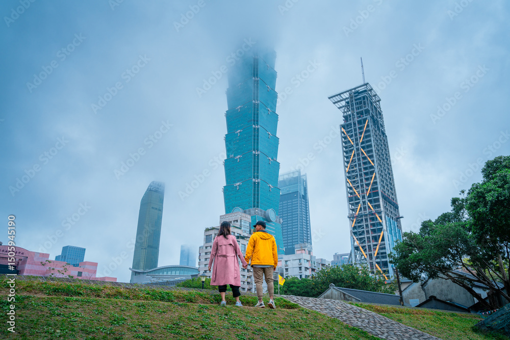 Obraz premium Sweet Couple Standing Near Foggy Taipei 101 – Urban Travel Scene in Taiwan