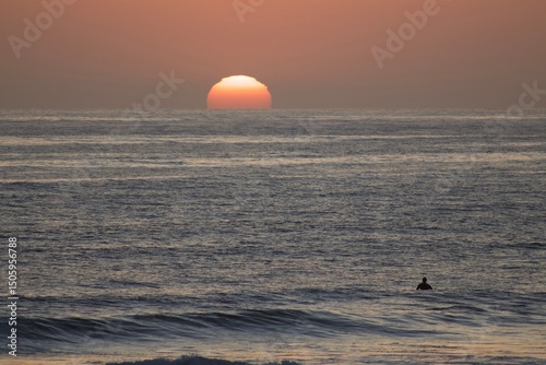 giant sun at ocean during golden hour sunset in pacific beach san diego california