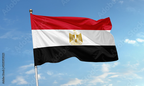 Egypt national flag with golden eagle emblem waving in the sky
