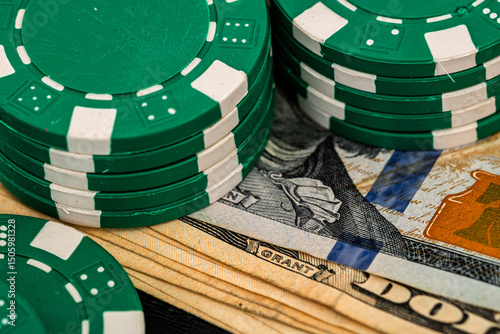 Stacks of poker chips with money on black background