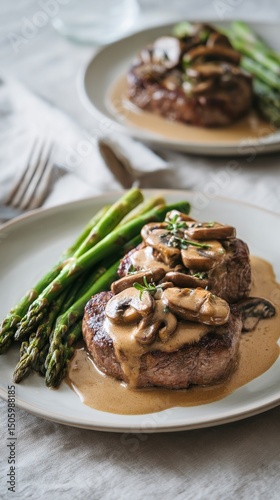 Delicious Steak With Mushroom Sauce Served With Asparagus on a Light Grey Table.
