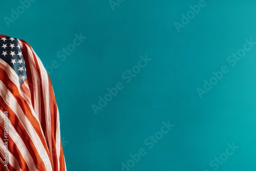 American Flag Draped on a Teal Surface Creating a Patriotic Visual Contrast.