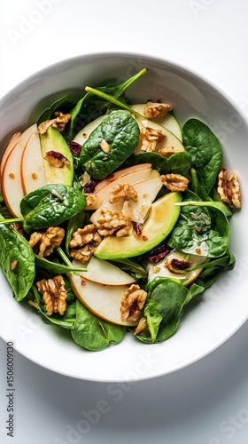 Fresh Spinach Salad With Apples, Walnuts, and Dried Cranberries Served in a Bowl