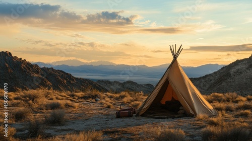 Sunset view of a traditional teepee nestled in a desert landscape.