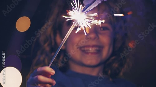 charming little girl holding fireworks outside. Cute blonde child with xmas dream. Happy kid enjoy the fire sparks. new year holidays eve of Christmas wish. Having fun Merry Christmas, Happy New Year,