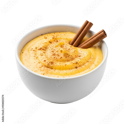 Corn pudding in a white bowl with powdered cinnamon on top and cinnamon sticks on transparent background