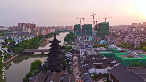 4k real time Aerial view of Shanghai Sijing Ancient Town at sunset, high angle view of historical buildings along river.